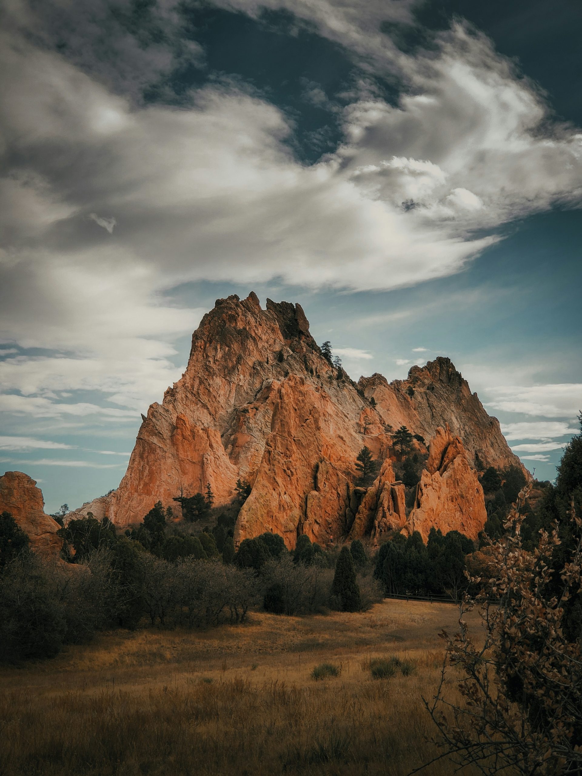 Dramatic red rock mountain under cloudy sky
