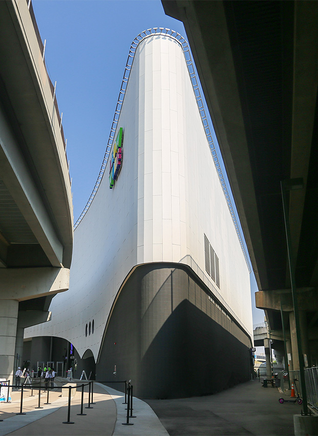 Modern curved building between elevated highways