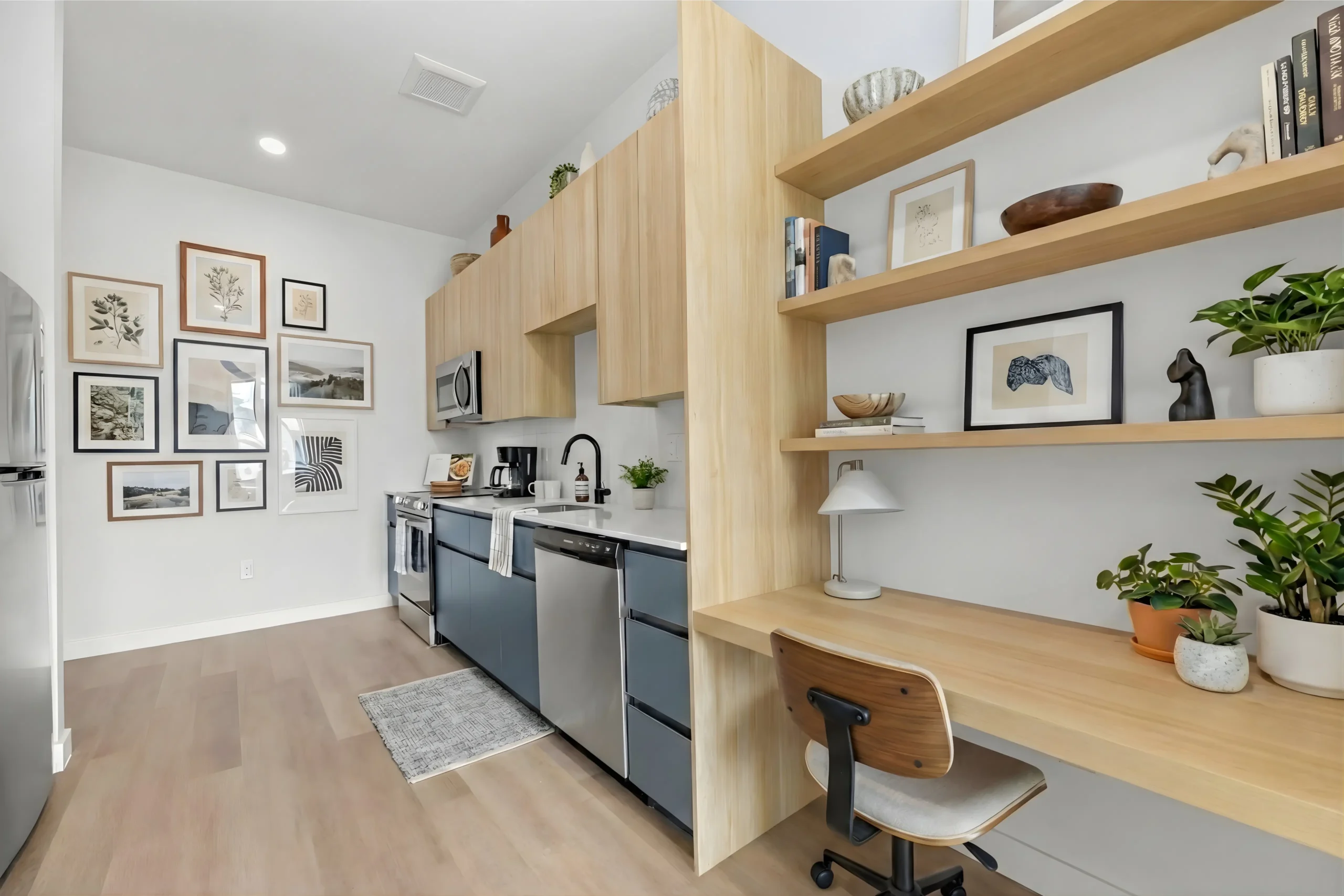 Modern kitchen with wooden shelves and home office desk